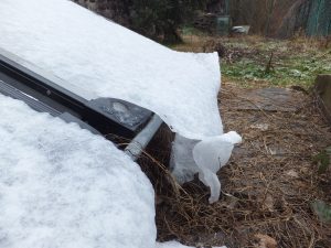 Snow "sheets" above some solar panels; pushed by the rain, they are sloping down folding themselves like real sheets