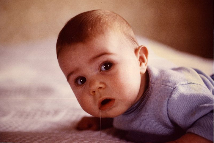 Three month old infant lying on stomach