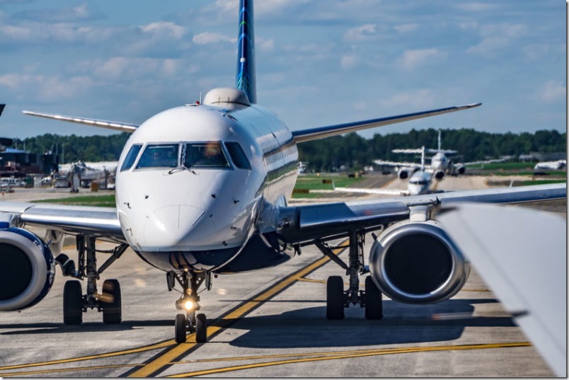 busy airport tarmac traffic before airplanes take off