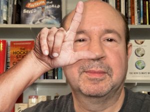 Michael E. Mann -screencap from video interview given to Rolling Stone magazine, with "L" hand gesture overlaid. Used under fair use exemption for "commentary or criticism to the public through parody or satire."