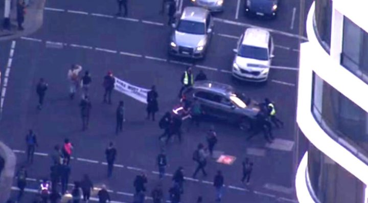 SUV Drives Through Protestors