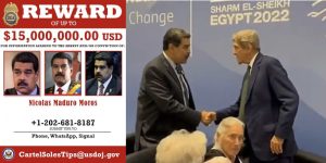John Kerry Shaking Hands with Maduro With Wanted Poster