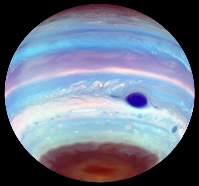 An artificially colored view of Jupiter as seen in ultraviolet light. In addition to the Great Red Spot, which appears blue, another oval feature can be seen in the brown haze at Jupiter's south pole. The oval, an area of concentrated haze, is possibly the result of mixing generated by a vortex higher up in the planet's ionosphere. These dark UV ovals also appear periodically at the north pole, though less often.

Credit
Troy Tsubota and Michael Wong, UC Berkeley