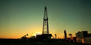 Oil drilling derrick in the sunset