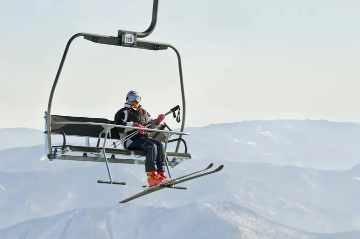 Skier on ski lift at resort in Siberia